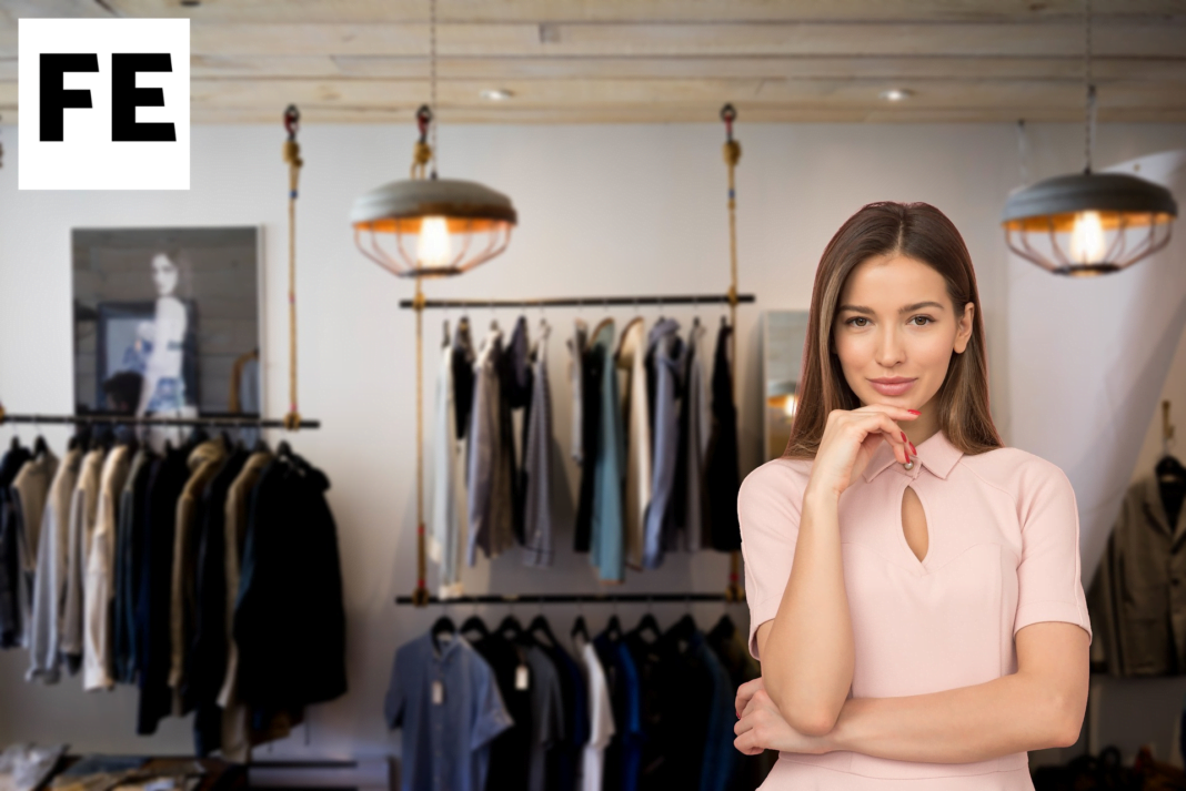 A woman browsing clothes on a rack in a store.