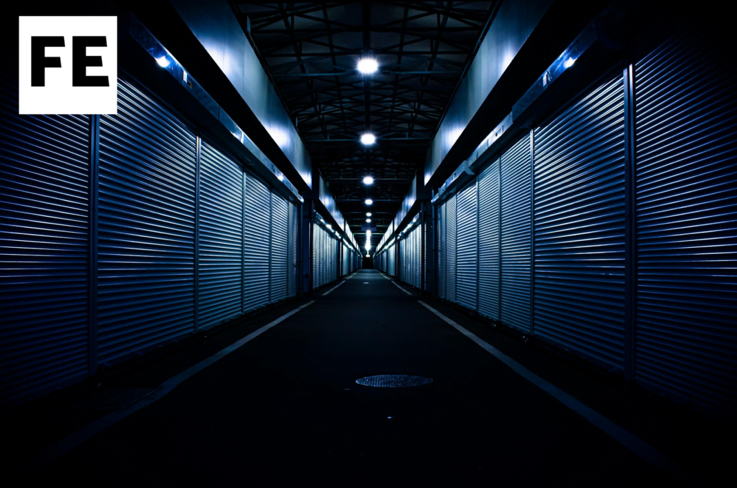 A dimly lit hallway illuminated by a single beam of light.