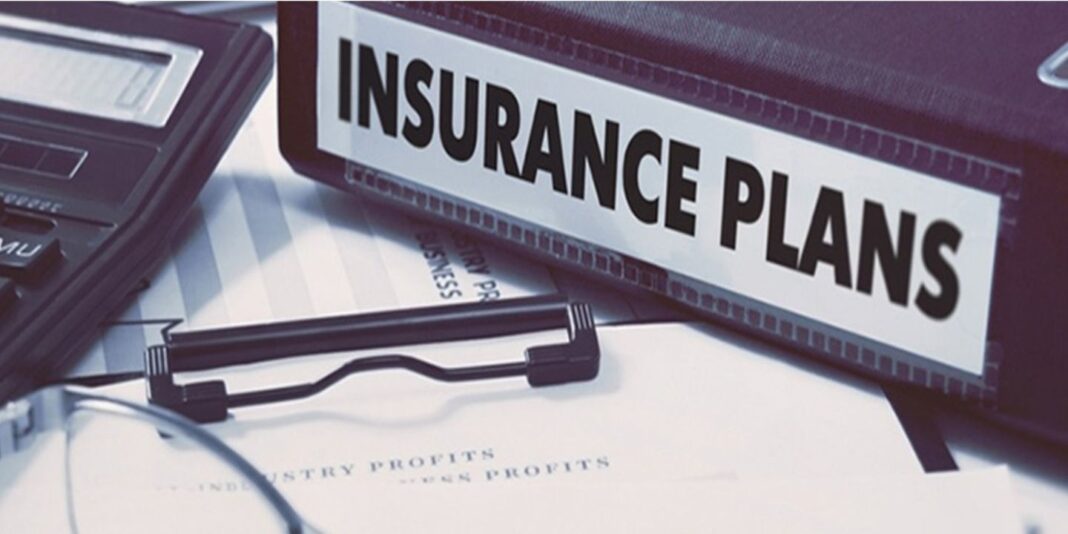 1. Various insurance plans laid out neatly on a desk. 2. Assorted insurance policies organized on a desk. 3. Different types of insurance plans displayed on a desk.